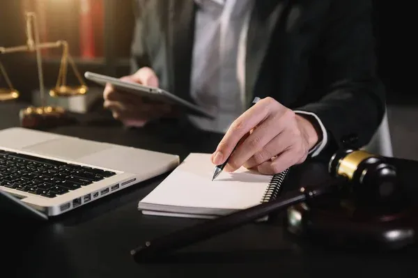 Lawyer reviewing documents beside a gavel