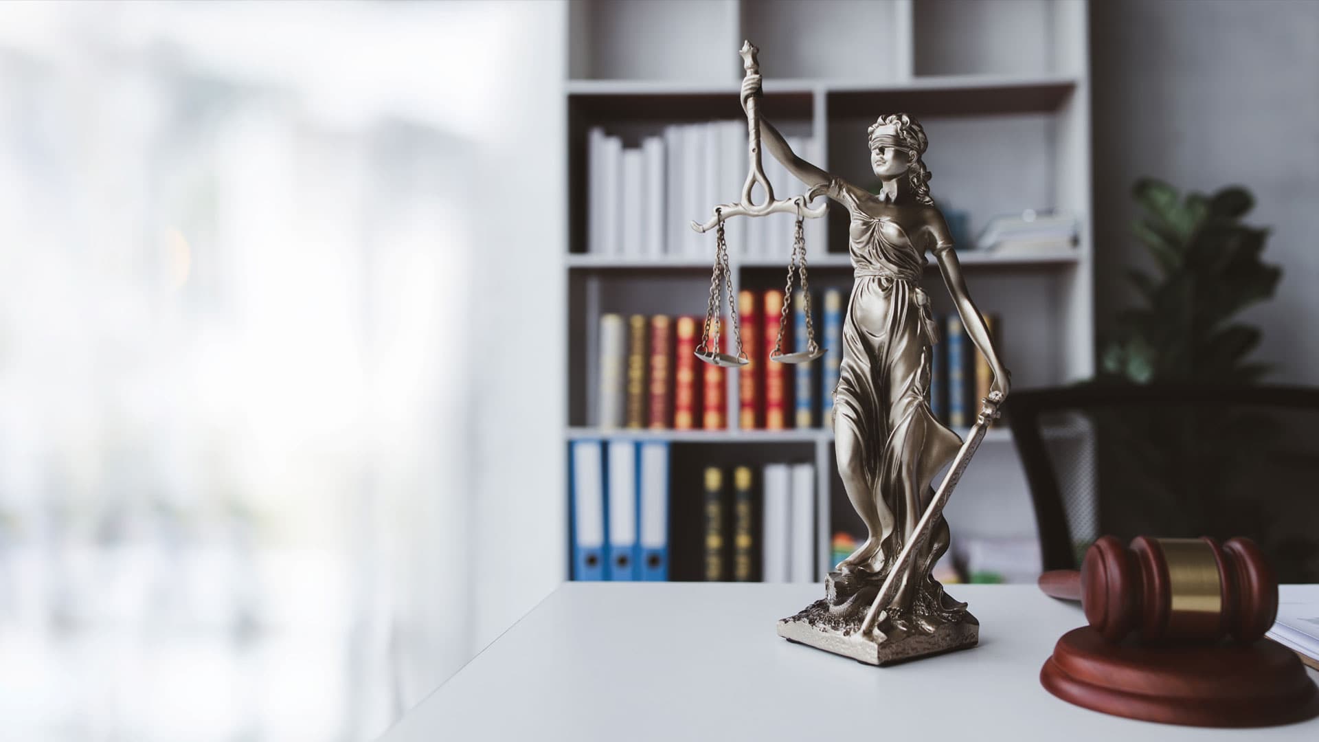 Statue of Lady Justice on a desk in a law office