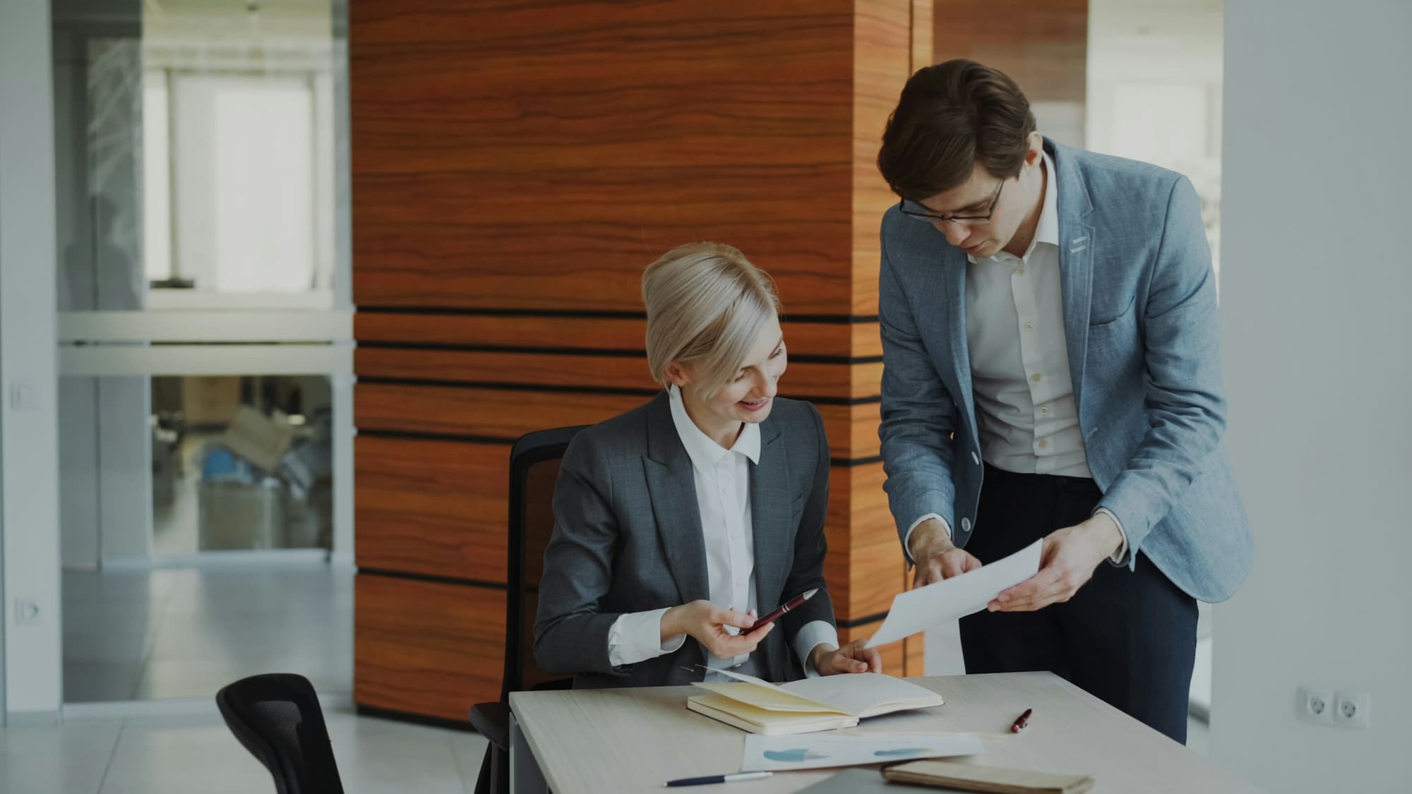 Two lawyers discussing documents at a desk