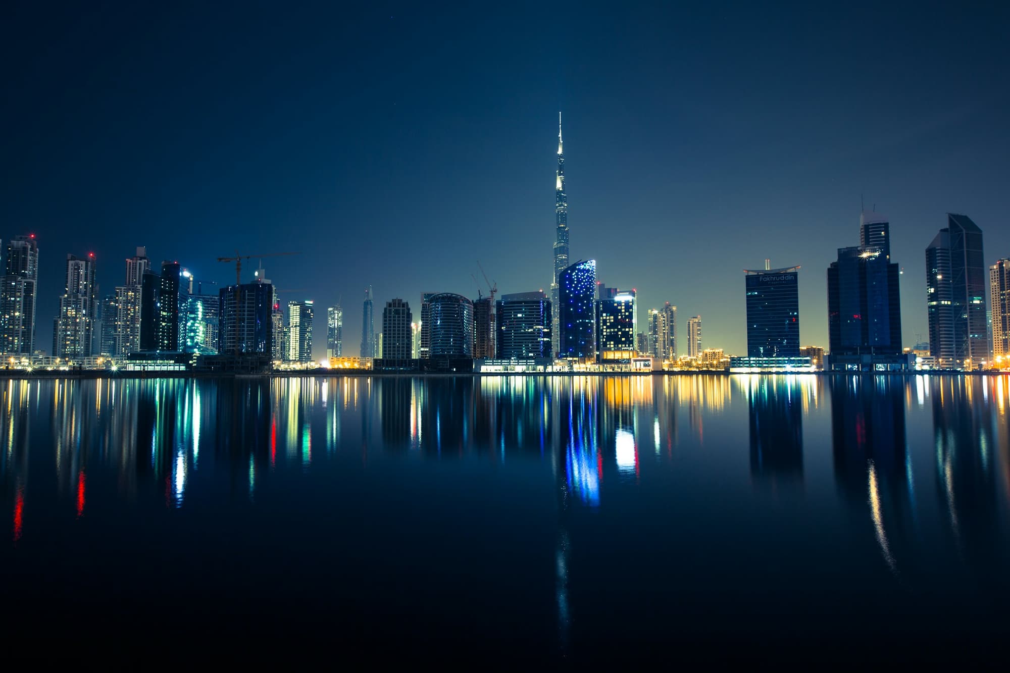 Dubai skyline at night reflected in water
