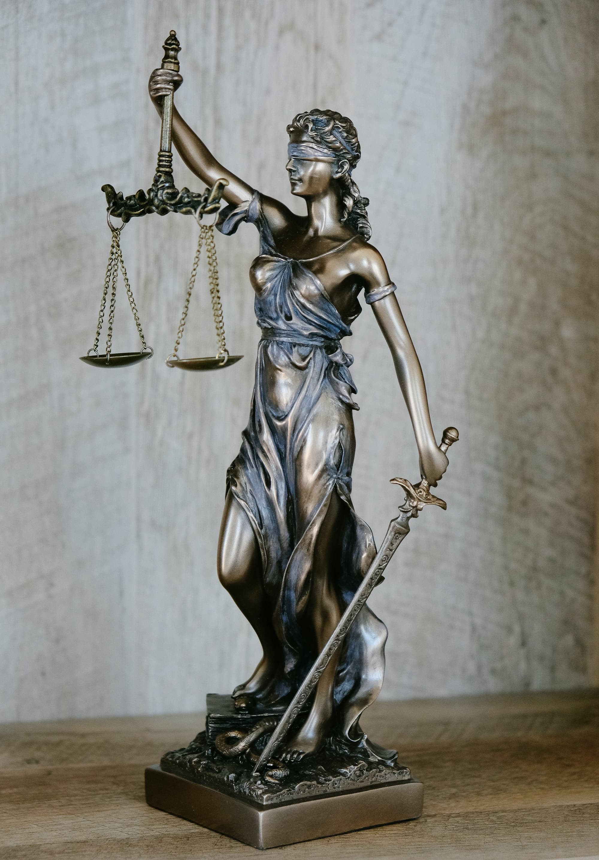 Bronze statue of Lady Justice with scales and sword