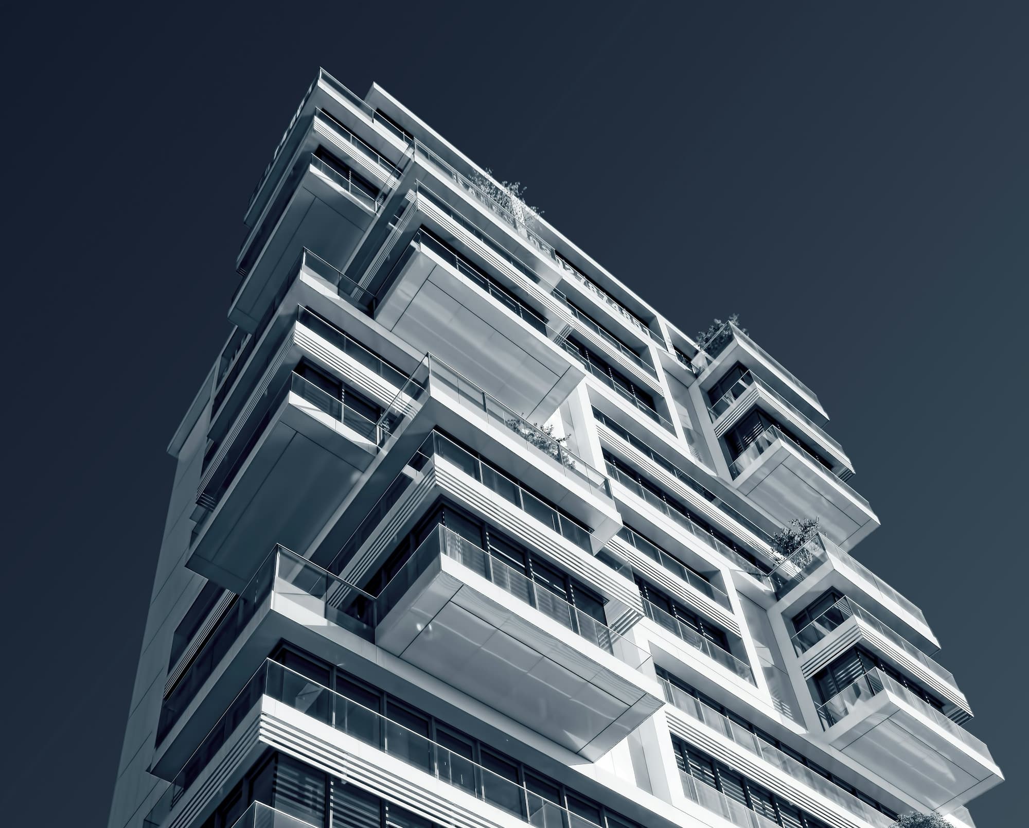 Modern residential tower against a dark sky