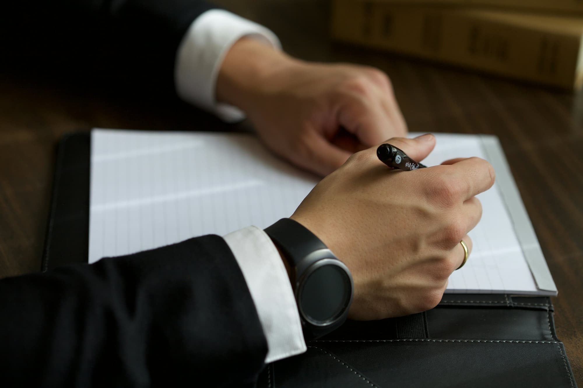 A lawyer in a suit signing a document